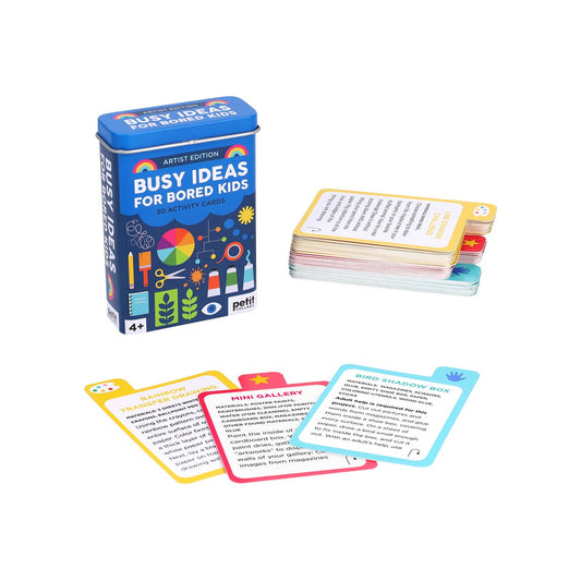 Blue tin box with colorful cards spread out on a white background
