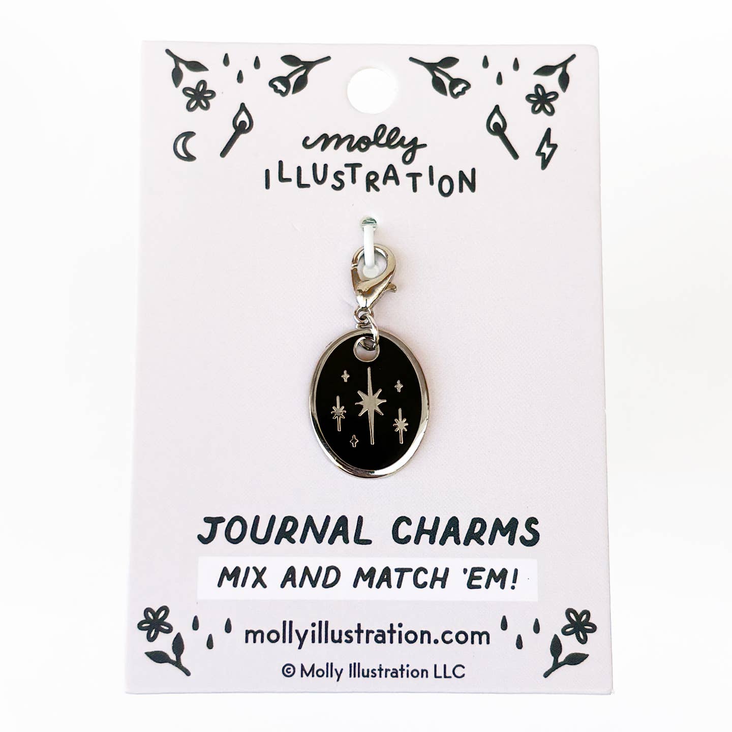 A black oval journal charm with silver-toned stars and a silver clasp, displayed on a white backing card branded Molly Illustration.