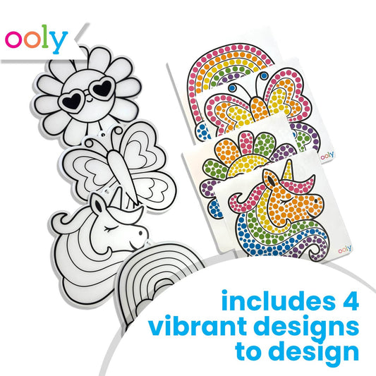 Detailed images of the four Rainbow Magic designs, both before and after the colorful gem stickers have been applied: sun with heart shaped sunglasses, butterfly, unicorn, and rainbow with clouds. Blue text on white background reads, "includes four vibrant designs to design"