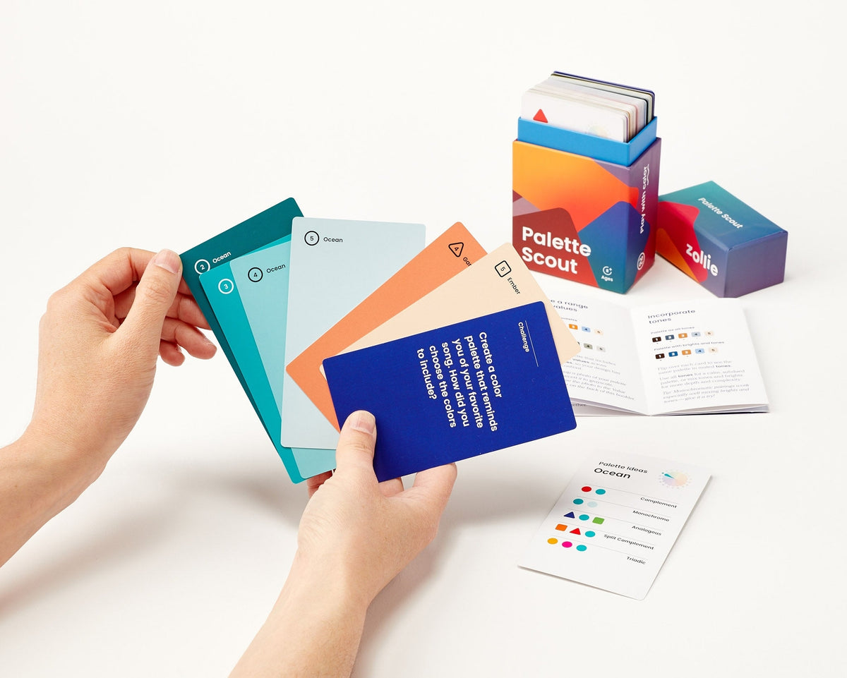 Palette Scout deck laid out with hint cards, instructional booklet, and retail packaging