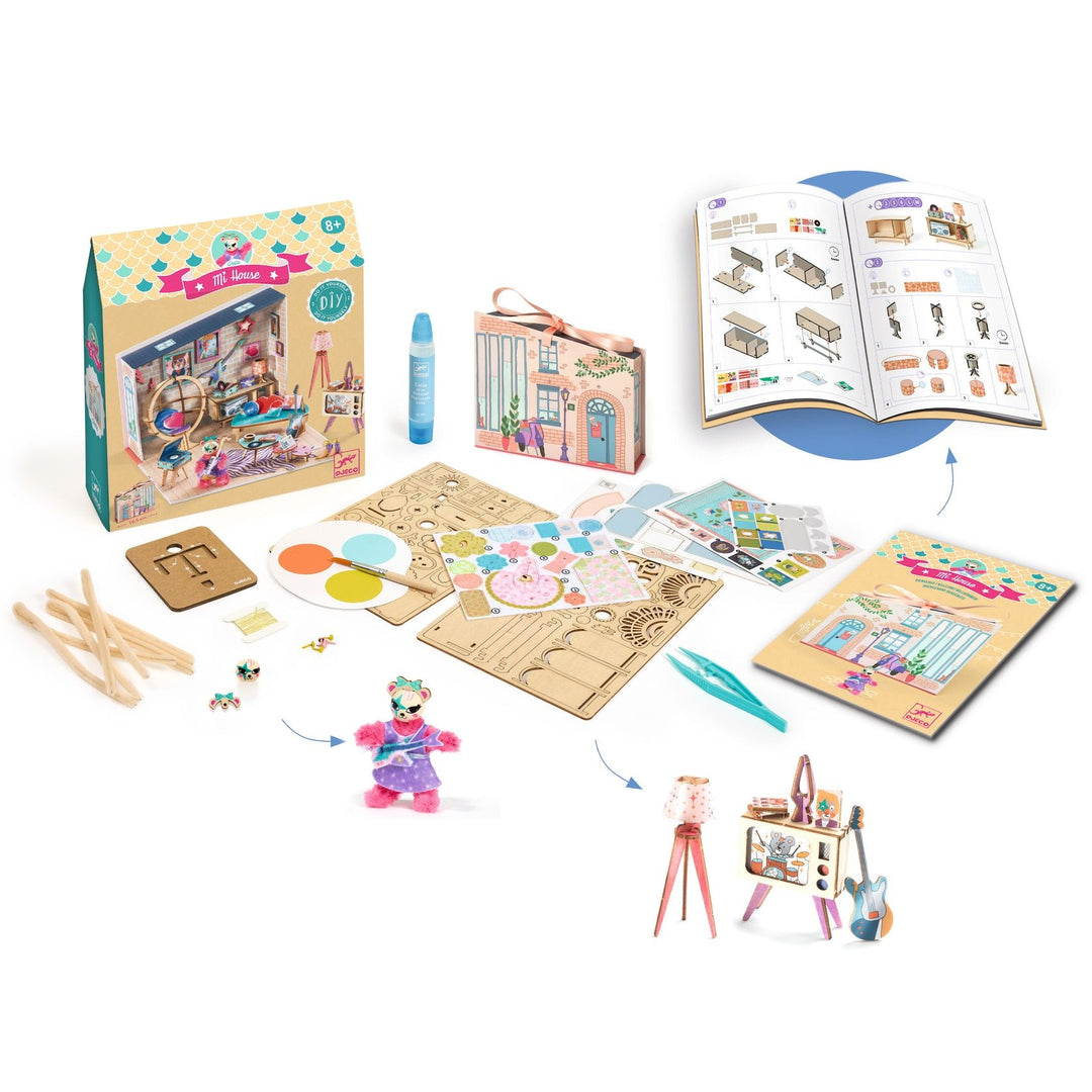 Image shows the kit packaging, instructional booklet, Stella figurine, glue applicator, tweezers, and laser cut wooden panels for model building