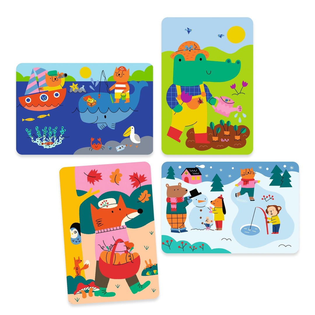 the colored in version of all four coloring cards, the autumnal fox, a winter snow scene, a summer scene with whales and a beach, and a spring scene with an alligator
