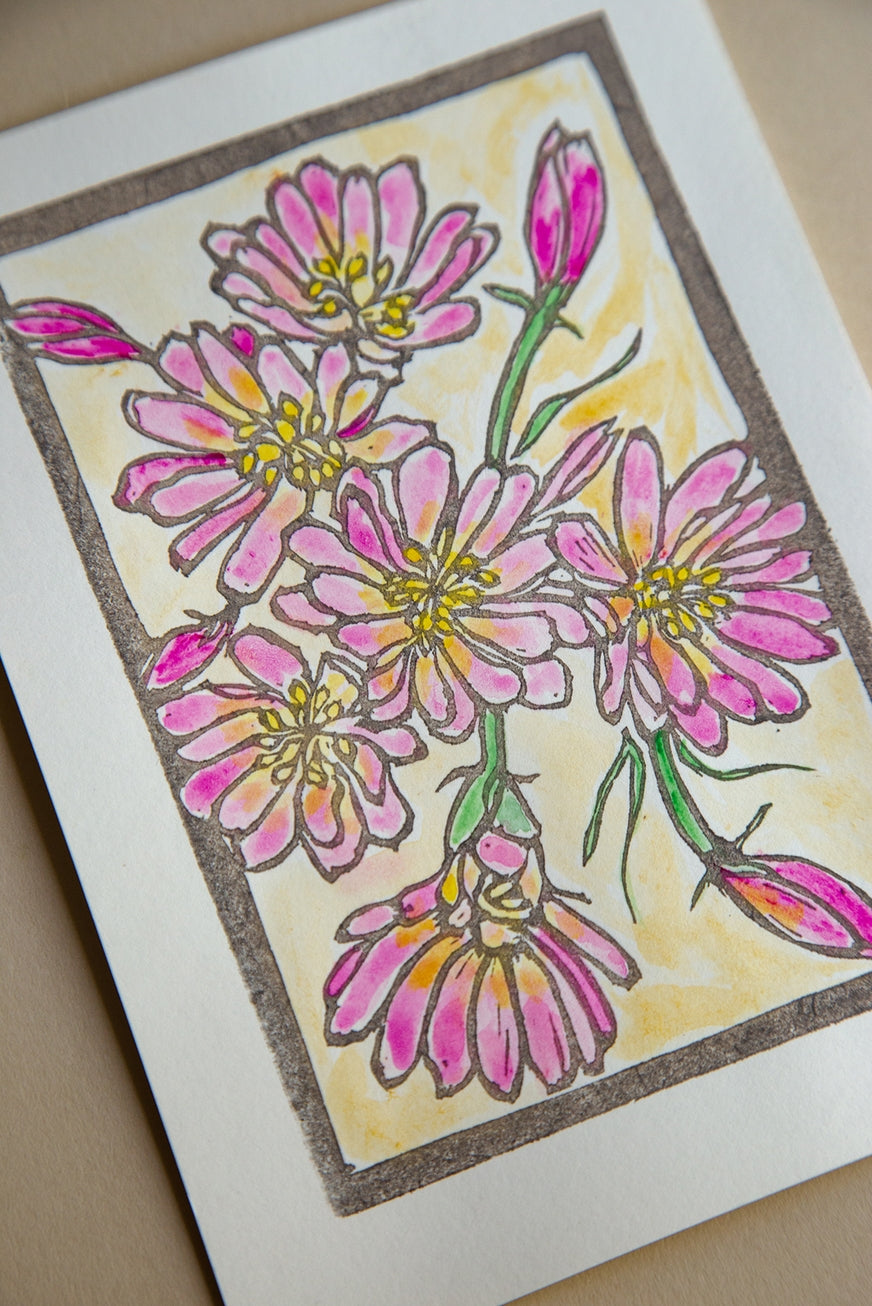 Card with pink floral design on a beige background