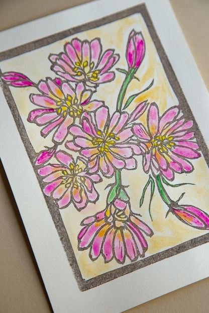 Card with pink floral design on a beige background