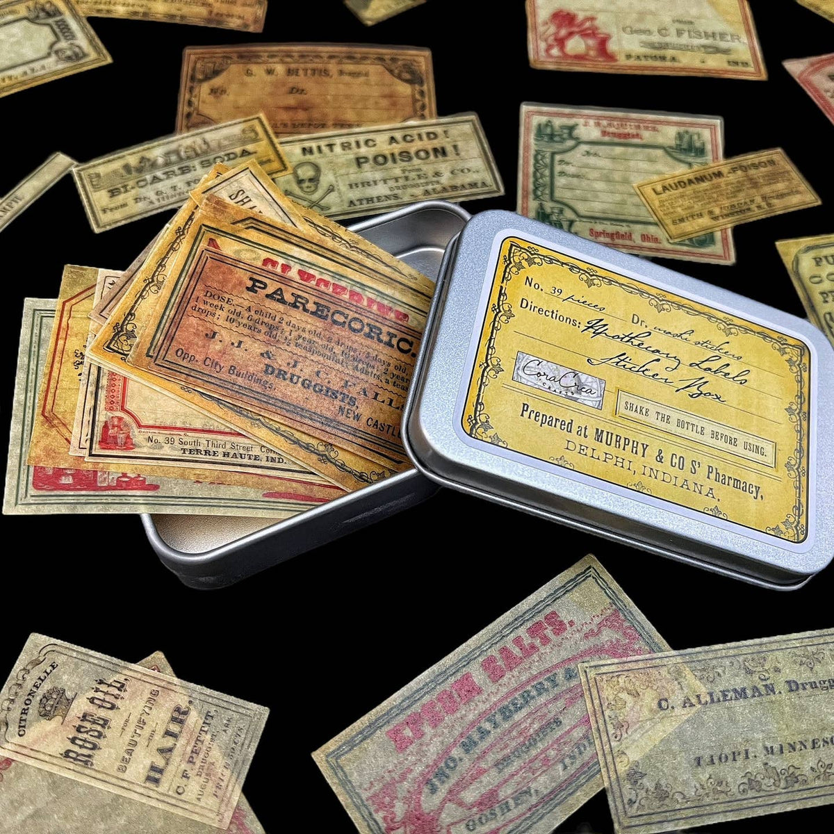 Vintage-style medicine labels scattered around a metal tin with similar design.