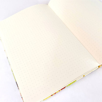 Open notebook with ivory dot grid pages on a white background