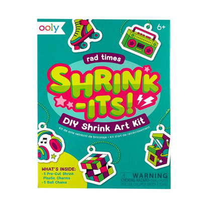 Ooly Rad Times Shrink-Its! DIY Shrink Art Kit box on a white background. The packaging features a bright teal background with retro-themed illustrations of a roller skate, boombox, headphones, and a Rubik's cube, along with product details and a choking hazard warning.