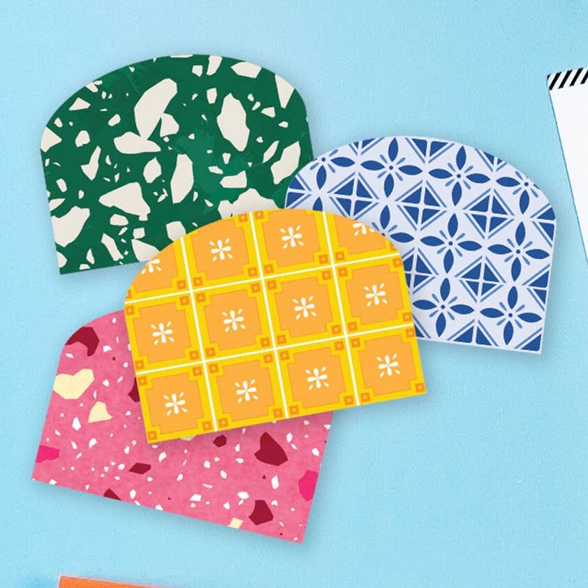 Four sticky pockets to add to notebooks in four different color patterns on a light blue background