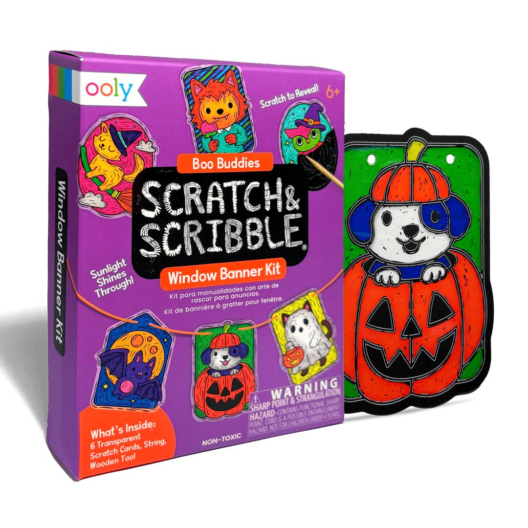Ooly Scratch & Scribble Window Banner Kit with its purple packaging box and a completed Halloween-themed window banner featuring a cartoon dog in a pumpkin hat on a green background.