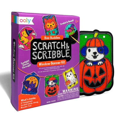 Ooly Scratch & Scribble Window Banner Kit with its purple packaging box and a completed Halloween-themed window banner featuring a cartoon dog in a pumpkin hat on a green background.