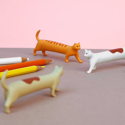 Three cat erasers shown standing next to three colored pencils
