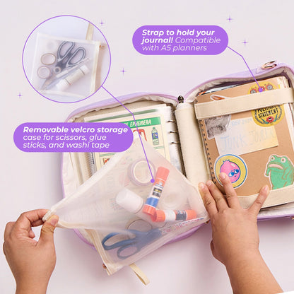 Photo of the interior of the Ultimate Journal Bag. White text on purple text bubbles reads, "Strap to hold your journal! Compatible with A5 planners. Removable velcro storage case for scissors, glue sticks, and washi tape"