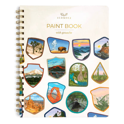 A spiral-bound paint book titled 'PAINT BOOK with gouache' by Icanoe2, featuring a cream cover decorated with multiple colorful shield-shaped landscape illustrations, shown on a plain white background.