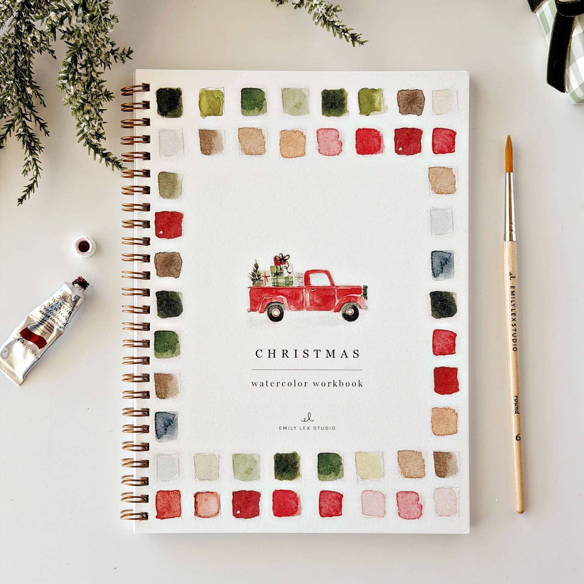 Cover of Emily Lex "Classic Christmas" Watercolor Workbook with a watercolor illustration of a red pick up truck carrying a bed full of presents and a tree