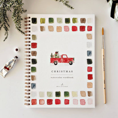 Cover of Emily Lex "Classic Christmas" Watercolor Workbook with a watercolor illustration of a red pick up truck carrying a bed full of presents and a tree