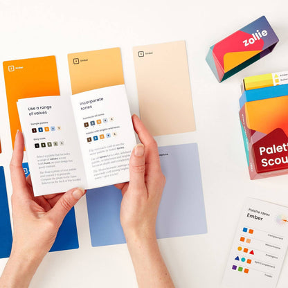 Palette Scout deck laid out with hint cards, instructional booklet, and retail packaging
