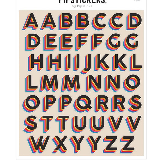 A sheet of alphabet stickers by Pipisticks featuring retro 3D-effect letters with black faces and layered red, orange, and blue shadows on a beige background.