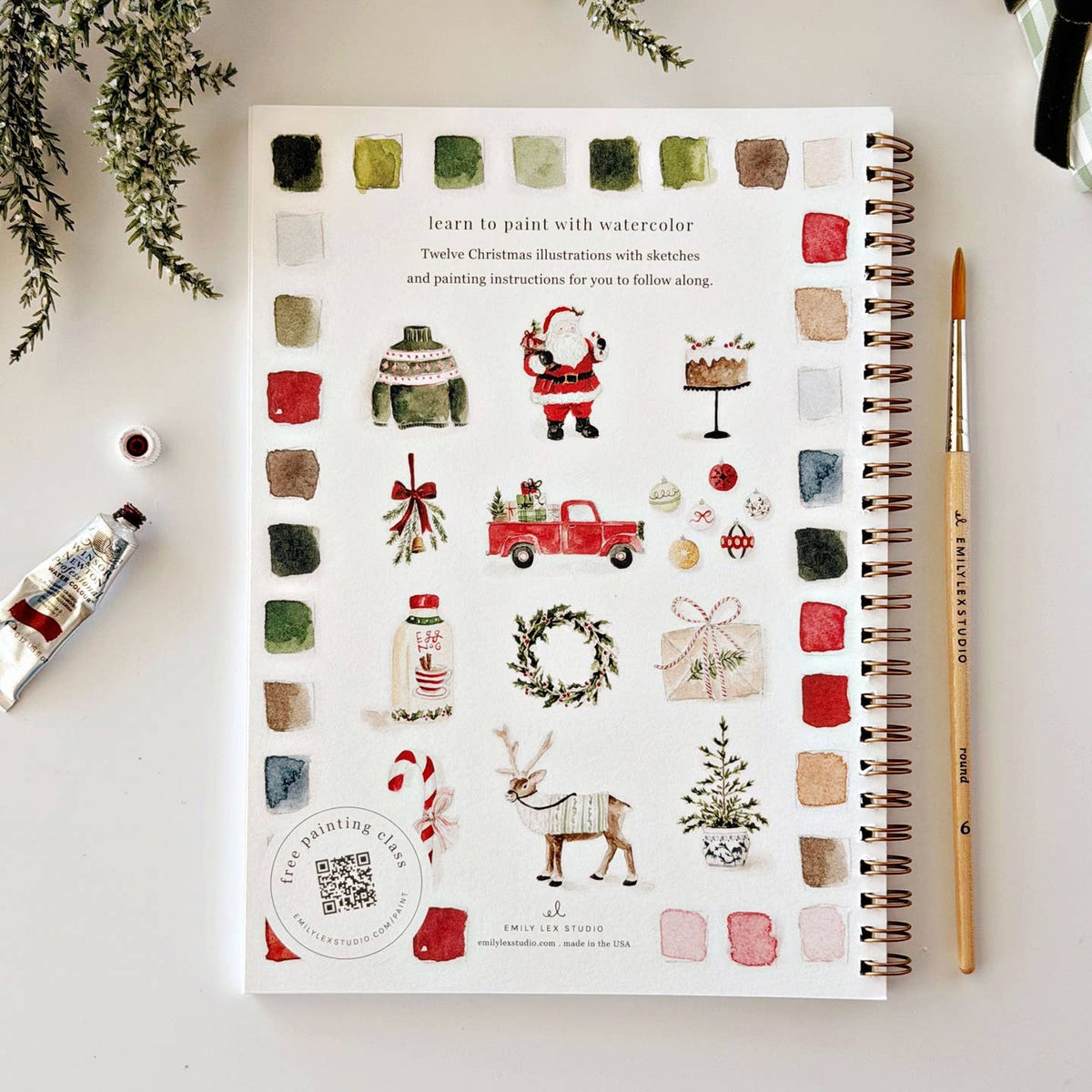 Back cover of Emily Lex "Classic Christmas" Watercolor Workbook featuring watercolor illustrations of a fair isle sweater, santa, decorated cake, evergreen bough, truck, ornaments, a wreath, reindeer, and candy cane