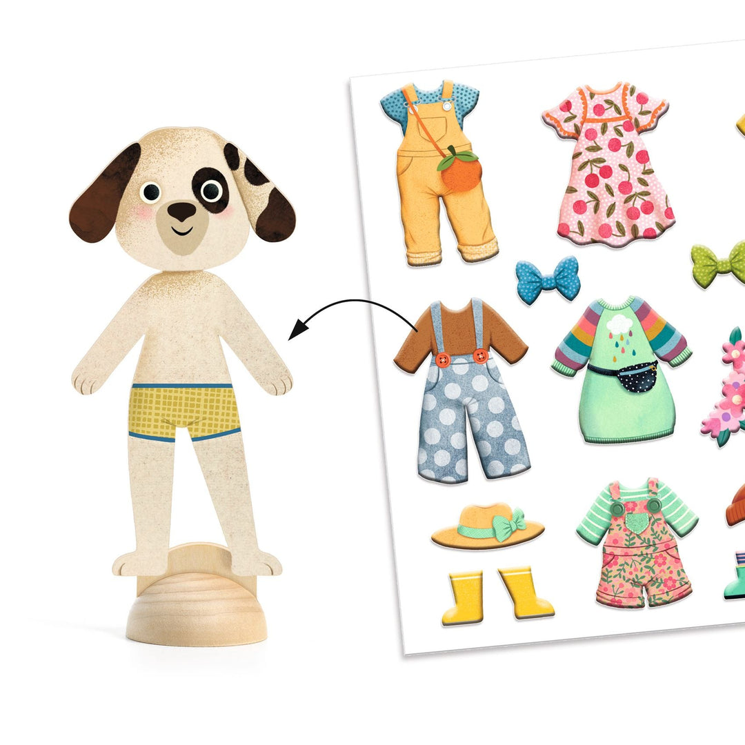 Wooden dog figurine wearing yellow striped underwear next to a card  full of sticker decal outfits