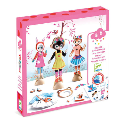Box with white and pink packaging featuring 3 wooden cat figurines dressed in colorful, fashionable outfits with changes of clothing at their feet