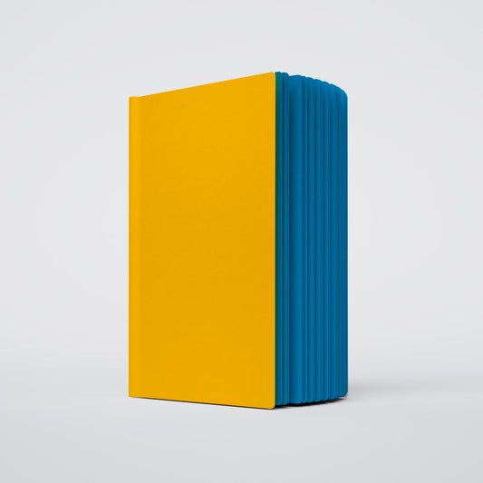 photo of a slightly open uglybook no.1 with a yellow cover and blue pages on a white background
