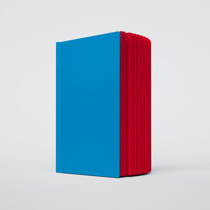 a partially open ugly book with a light blue cover with red interior pages