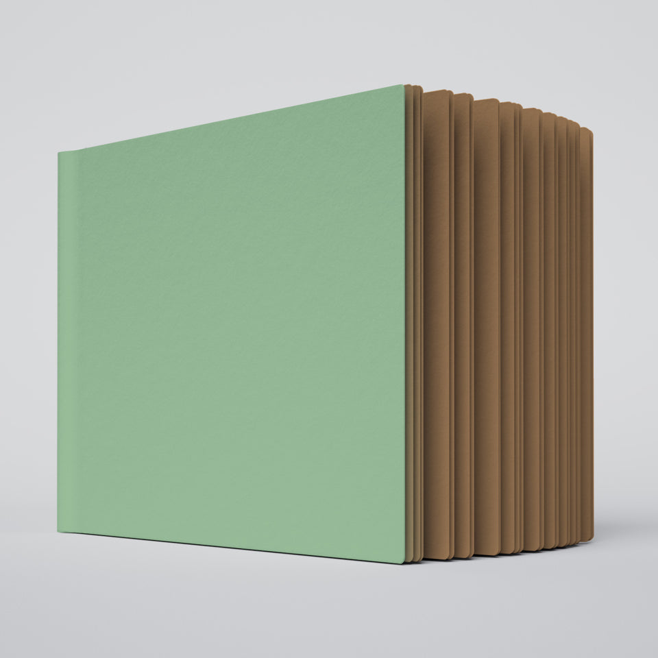 partially open ugly book with mint green cover and kraft brown interior pages