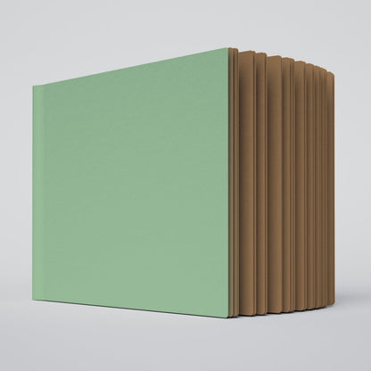partially open ugly book with mint green cover and kraft brown interior pages
