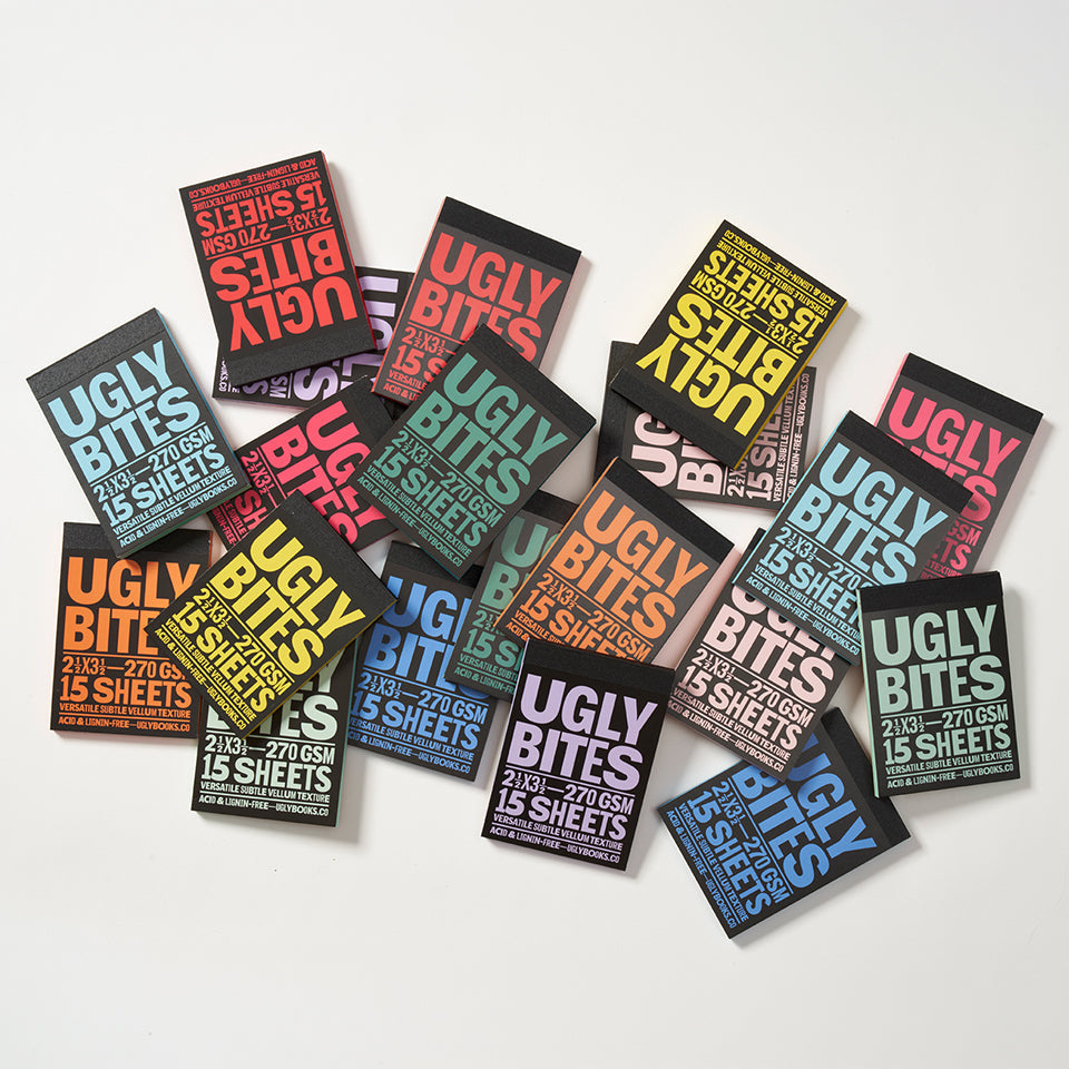View of all the colors of the Uglybite pads scattered on a white background