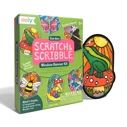 Ooly Scratch & Scribble Garden Window Banner Kit shown with its green retail box and a completed colorful banner featuring a frog, sun, and mushrooms on a white background.