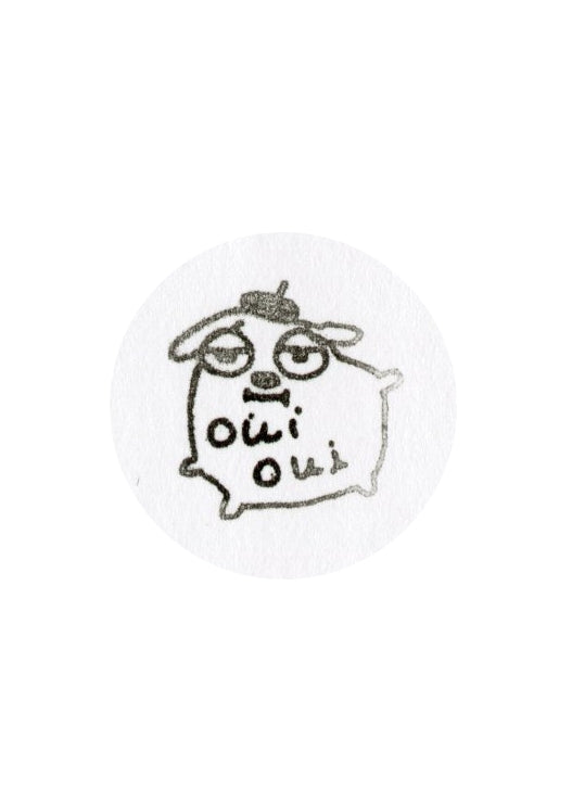 A circular stamp image featuring a hand-drawn black ink cartoon dog wearing a beret with the text 'oui oui' written below it, set against a plain white background.