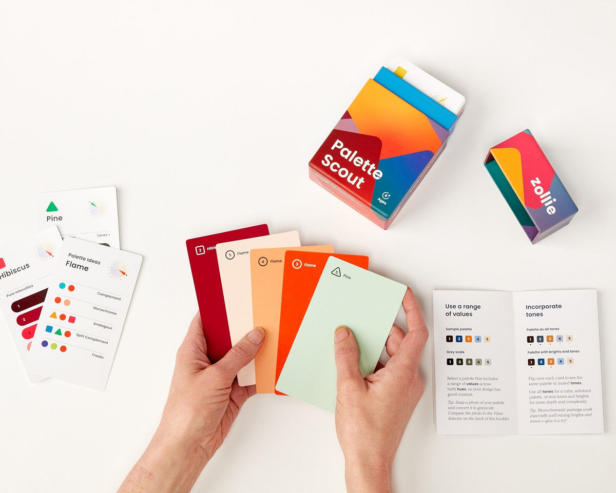 Palette Scout deck laid out with hint cards, instructional booklet, and retail packaging
