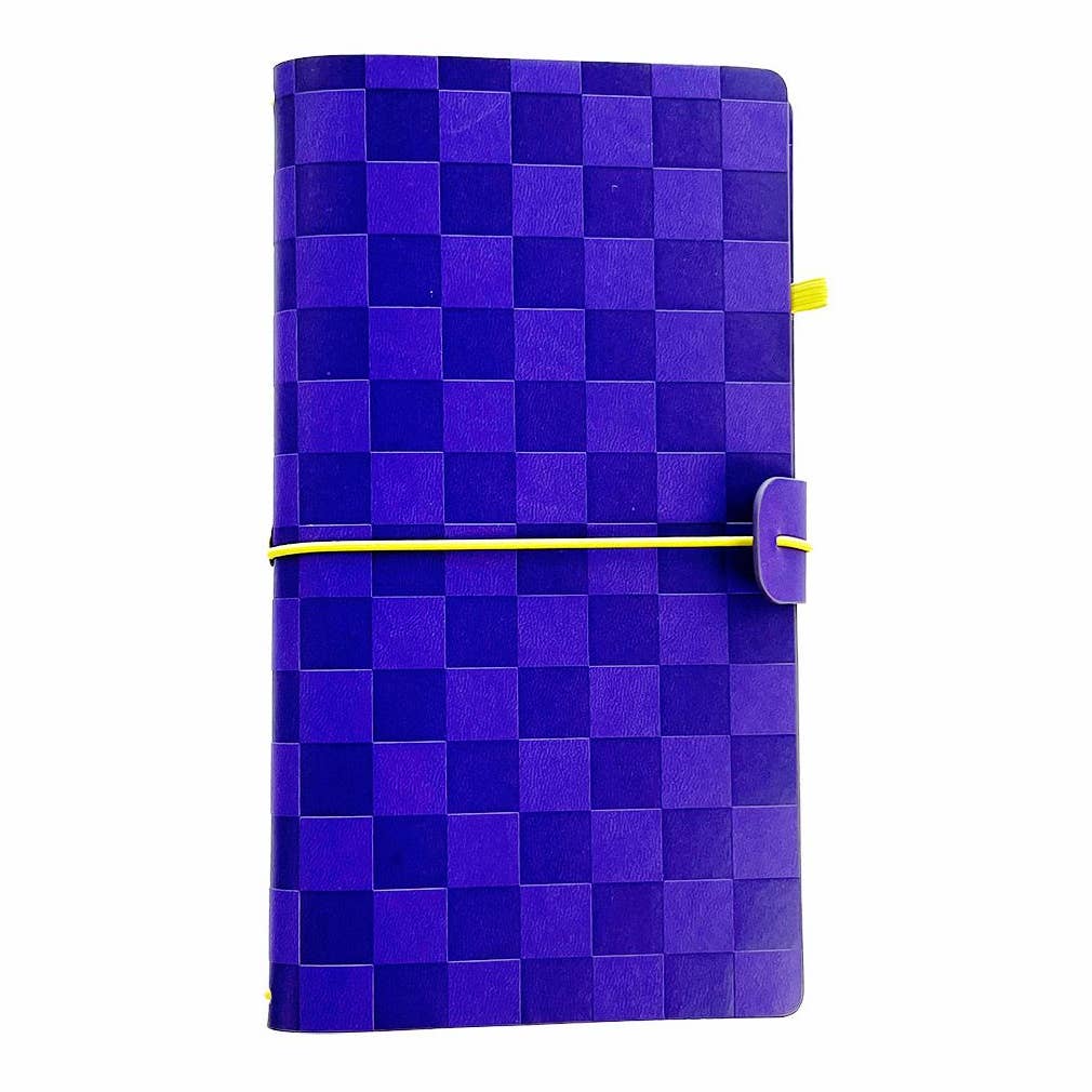 Pipsticks traveler notebook cover with a blue checkerboard pattern cover, secured by a yellow elastic band and featuring a purple tab closure.