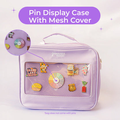 Ultimate Journal Bag in Lavender showing a detailed image of the clear window on the front of the bag with a variety of enamel pins on display. White text in a purple text bubble reads "pin display case with mesh cover"