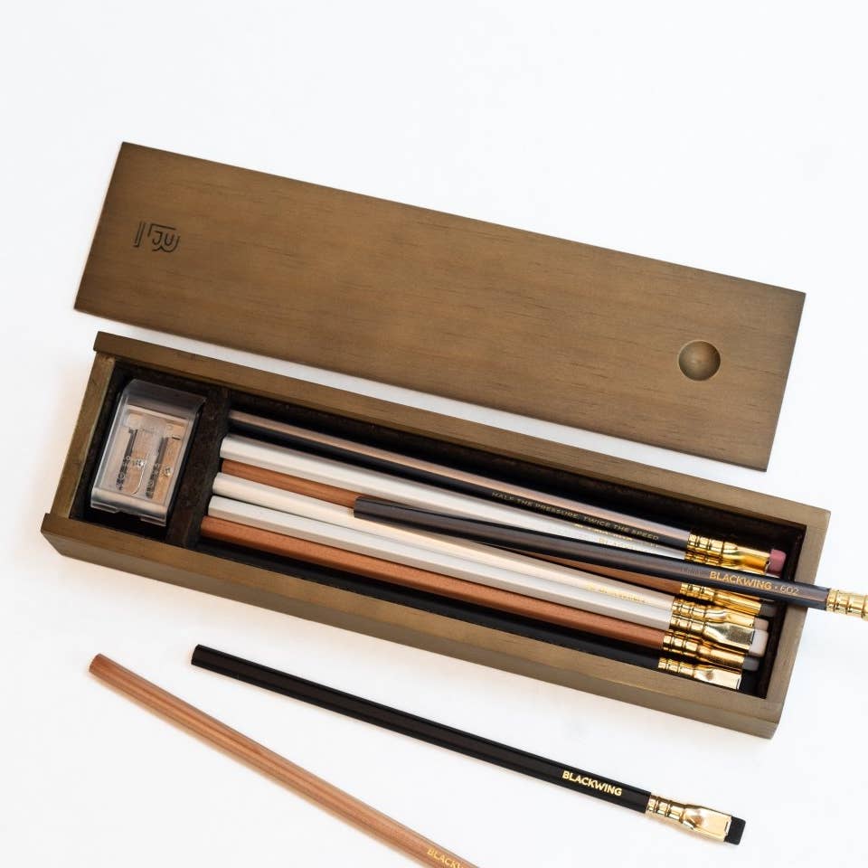 Photo of the Rustic Blackwing box open showing the contents of the four different styles of Blackwing pencils and the 2 step long point sharpener