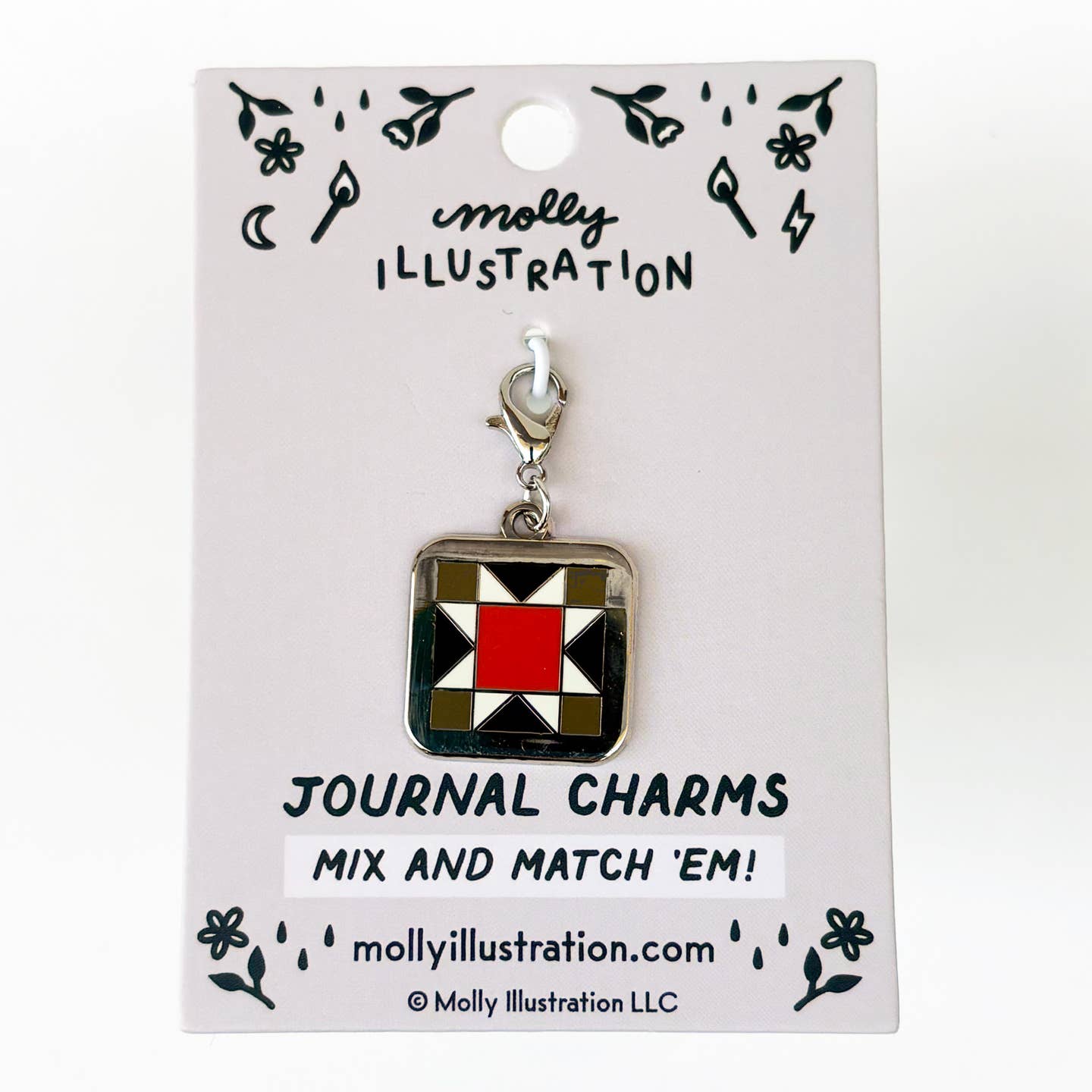 A journal charm with a geometric patchwork design in red, black, white, and silver, attached to a silver lobster clasp and displayed on a white backing card by Molly Illustration.