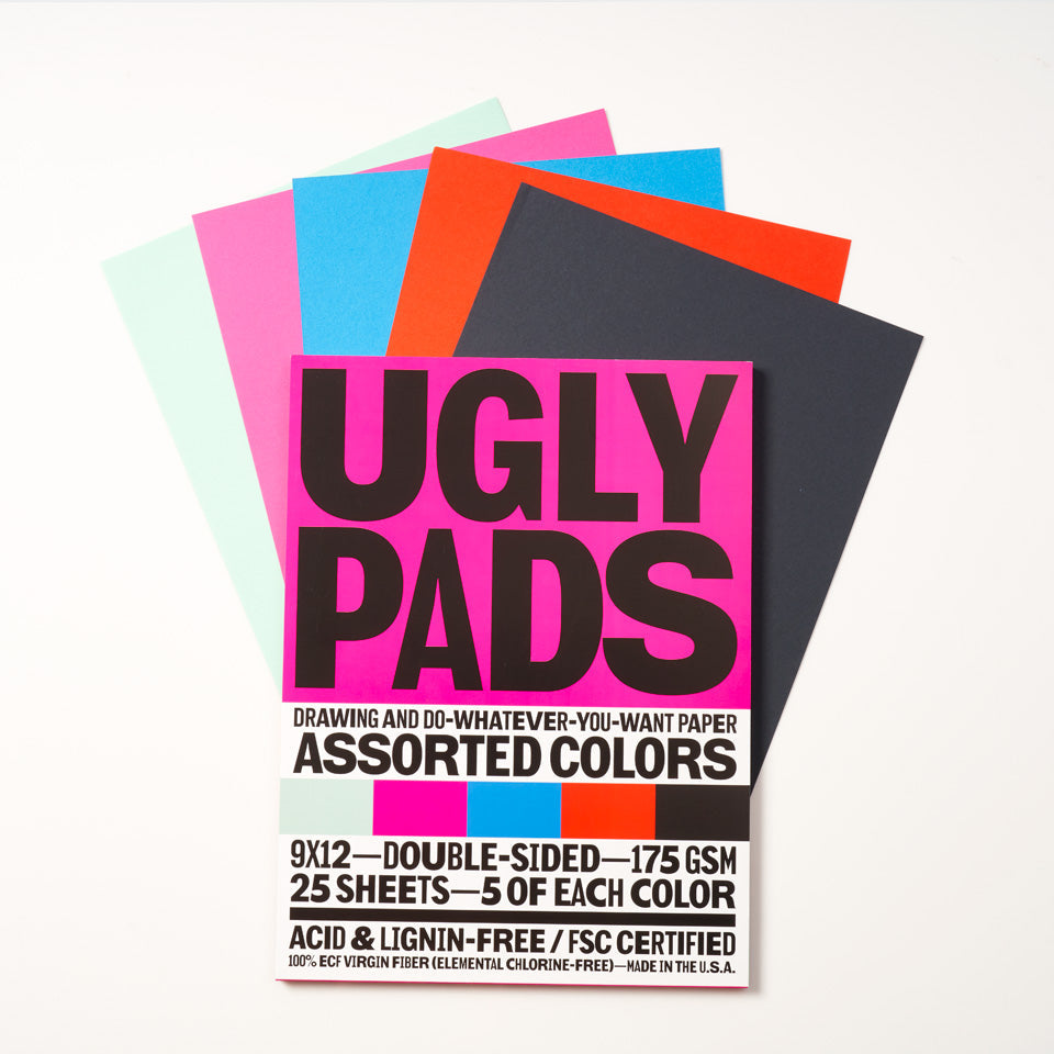 Packaging of "frostbite" Uglypad with single sheets spread around it, in mint, pink, sky blue, red, and black